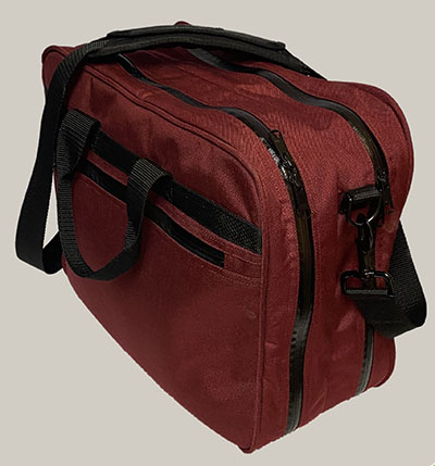 red cordura fold-out tote bag with weatherproof exposed two-way zippers, side pockets with weatherproof exposed zippers, shoulder strap, and side strap handles